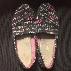 Black Toms with “Let Love Rule” Written on Them